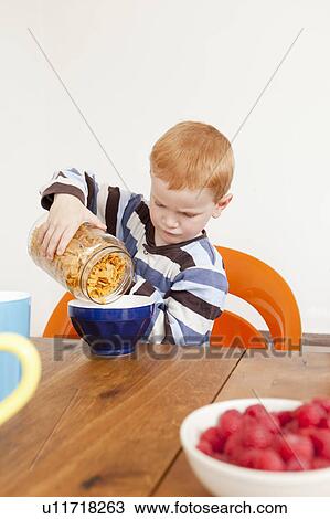 Boy pouring himself bowl of cereal View Large Photo Image Stock Image - Boy pouring himself bowl of cereal. Fotosearch