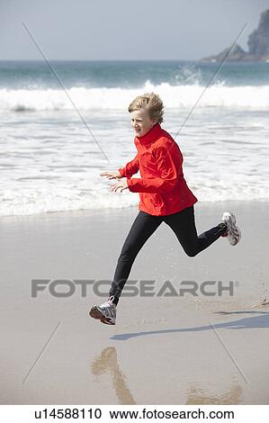 Boy running on beach View Large Photo Image Stock Image - Boy running on beach. Fotosearch