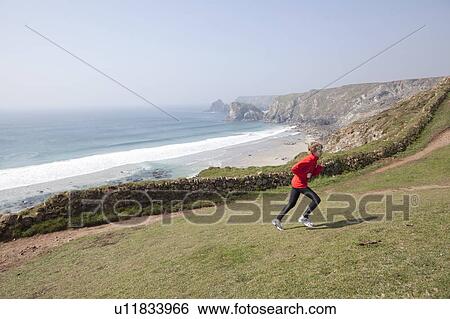 Boy running on cliffs over beach View Large Photo Image Stock Photograph - Boy running on cliffs over beach. Fotosearch