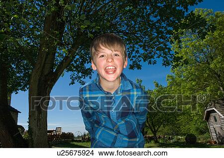 Boy shouting in backyard View Large Photo Image Picture - Boy shouting in backyard. Fotosearch
