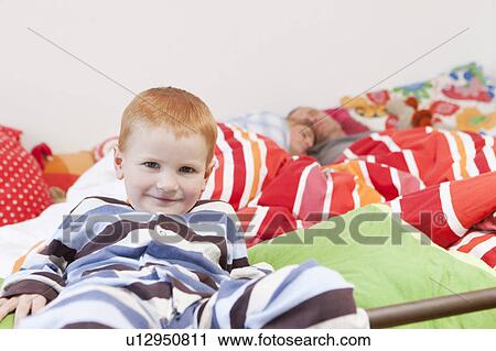 Boy sneaking into sleeping parents’ bed View Large Photo Image Stock Image - Boy sneaking into sleeping parents’ bed. Fotosearch