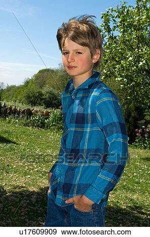 Boy standing in backyard View Large Photo Image Stock Photo - Boy standing in backyard. Fotosearch