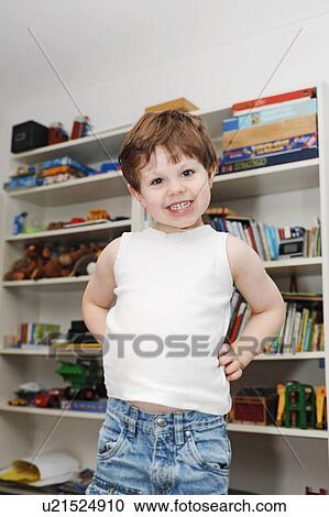 Boy standing in his bedroom View Large Photo Image Stock Image - Boy standing in his bedroom. Fotosearch