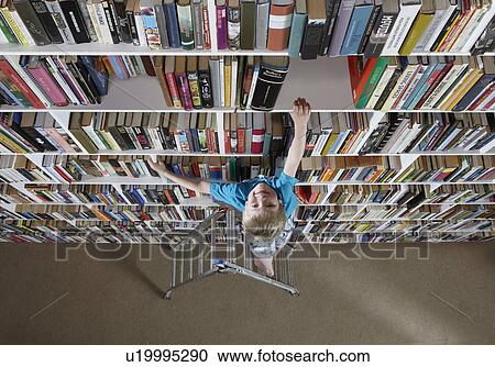 Boy using stepladder on bookshelves View Large Photo Image Stock Image - Boy using stepladder on bookshelves. Fotosearch