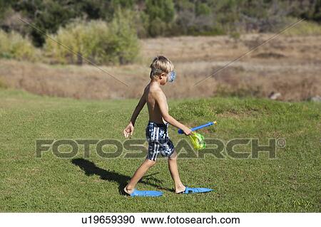 Stock Image - Boy wearing flippers, snorkel and mask. Fotosearch