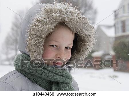 Boy wearing fur hood in snow View Large Photo Image Stock Photo - Boy wearing fur hood in snow. Fotosearch
