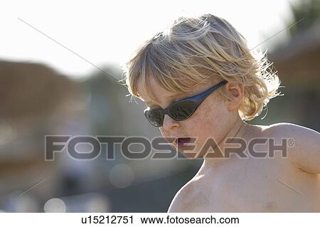 Boy wearing sunglasses outdoors View Large Photo Image Stock Image - Boy wearing sunglasses outdoors. Fotosearch