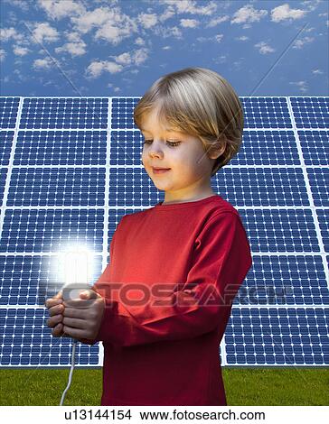 Boy with light bulb by solar panel View Large Photo Image Picture - Boy with light bulb by solar panel. Fotosearch
