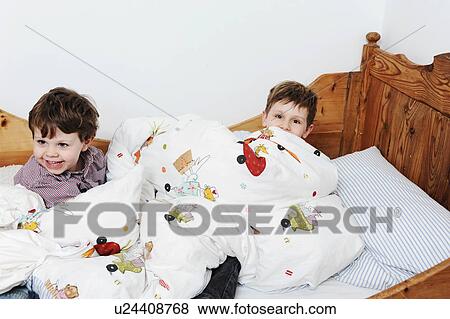 Boys playing in bed View Large Photo Image Stock Photo - Boys playing in bed. Fotosearch