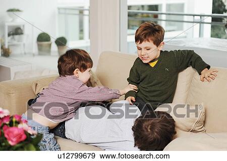 Boys playing on the sofa View Large Photo Image Stock Photo - Boys playing on the sofa. Fotosearch