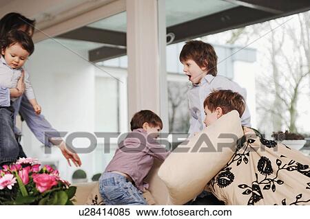 Boys playing on the sofa View Large Photo Image Stock Photography - Boys playing on the sofa. Fotosearch