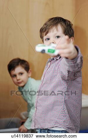 Stock Photo - Boys playing with toy cars. Fotosearch