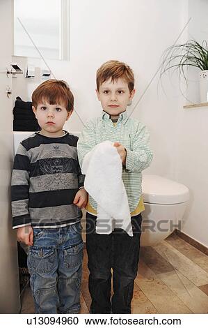 Stock Image - Boys washing their hands in bathroom. Fotosearch