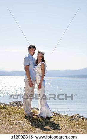 Bride and groom standing outdoors View Large Photo Image Stock Photography - Bride and groom standing outdoors. Fotosearch
