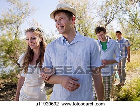 Bride and groom walking arm-in-arm View Large Photo Image Stock Image - Bride and groom walking arm-in-arm. Fotosearch