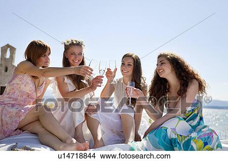 Bride drinking champagne with friends View Large Photo Image Picture - Bride drinking champagne with friends. Fotosearch