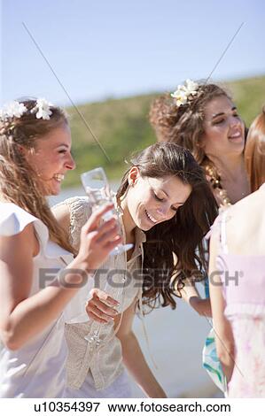 Bride drinking champagne with friends View Large Photo Image Stock Photo - Bride drinking champagne with friends. Fotosearch