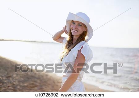 Stock Image - Bride smiling on beach. Fotosearch