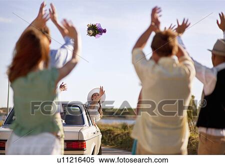 Bride throwing bouquet from car View Large Photo Image Stock Photography - Bride throwing bouquet from car. Fotosearch