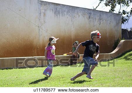 Stock Photo - Brother and sister playing in backyard. Fotosearch