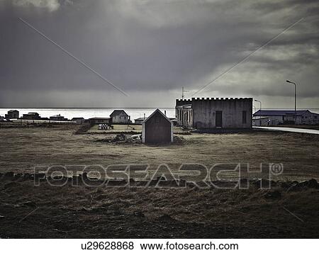 Buildings on coastline under cloudy sky View Large Photo Image Stock Photo - Buildings on coastline under cloudy sky. Fotosearch