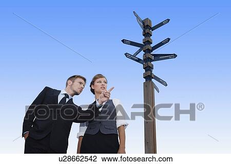 Stock Image - Business people at crossroads. Fotosearch