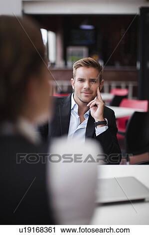 Stock Image - Business people at lunch together. Fotosearch