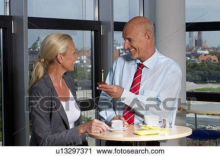 Stock Image - Business people celebrating birthday. Fotosearch