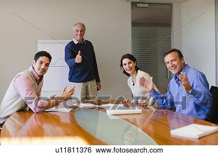 Business people cheering in meeting View Large Photo Image Stock Photograph - Business people cheering in meeting. Fotosearch