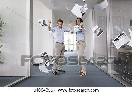 Stock Photo - Business people cheering in office. Fotosearch