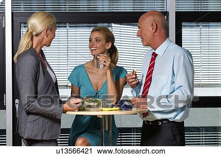 Business people eating lunch in office View Large Photo Image Stock Image - Business people eating lunch in office. Fotosearch