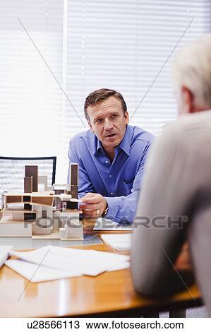 Business people examining model View Large Photo Image Stock Image - Business people examining model. Fotosearch