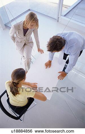 Business people examining plans View Large Photo Image Stock Photograph - Business people examining plans. Fotosearch