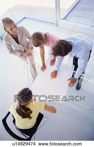Business people examining plans together View Large Photo Image Picture - Business people examining plans together. Fotosearch