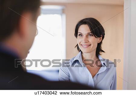 Stock Image - Business people greeting in office. Fotosearch