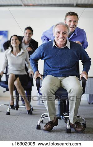 Business people having chair race View Large Photo Image Stock Photography - Business people having chair race. Fotosearch