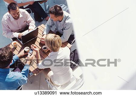 Business people having coffee together View Large Photo Image Stock Image - Business people having coffee together. Fotosearch