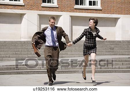 Business people holding hands outdoors View Large Photo Image Stock Photograph - Business people holding hands outdoors. Fotosearch