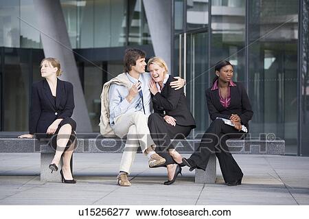 Business people ignoring couple on bench View Large Photo Image Stock Photo - Business people ignoring couple on bench. Fotosearch