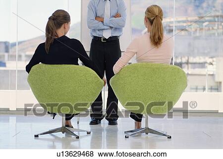 Stock Photo - Business people in meeting together. Fotosearch