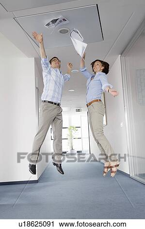 Stock Image - Business people jumping for joy. Fotosearch