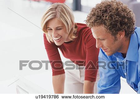 Business people leaning on desk together View Large Photo Image Stock Photograph - Business people leaning on desk together. Fotosearch