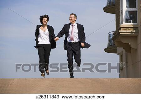 Business people running on street View Large Photo Image Stock Photo - Business people running on street. Fotosearch