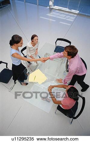 Business people shaking hands in office View Large Photo Image Stock Photography - Business people shaking hands in office. Fotosearch