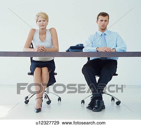 Business people sitting at desk View Large Photo Image Stock Photo - Business people sitting at desk. Fotosearch
