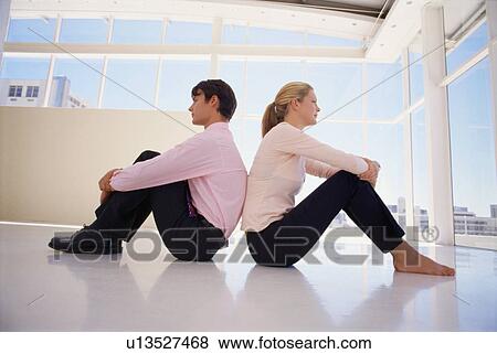 Stock Photo - Business people sitting back-to-back. Fotosearch