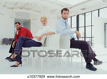 Business people sitting in lobby View Large Photo Image Stock Photo - Business people sitting in lobby. Fotosearch