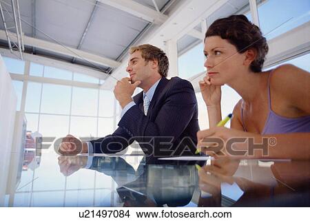 Picture - Business people sitting in meeting. Fotosearch