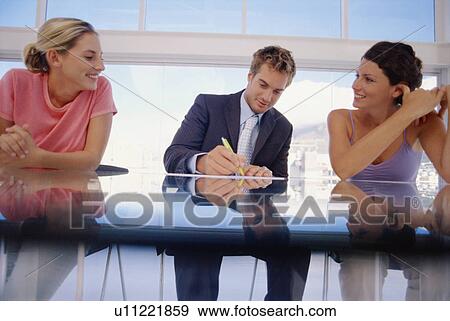 Business people sitting in meeting View Large Photo Image Stock Photo - Business people sitting in meeting. Fotosearch