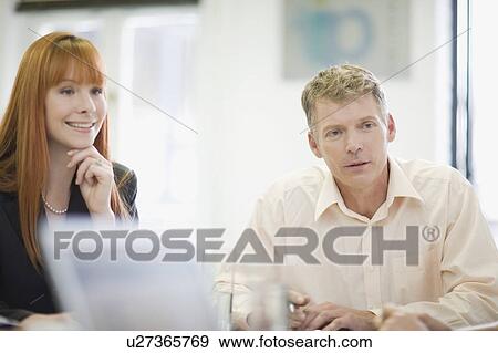 Business people sitting in meeting View Large Photo Image Stock Photo - Business people sitting in meeting. Fotosearch
